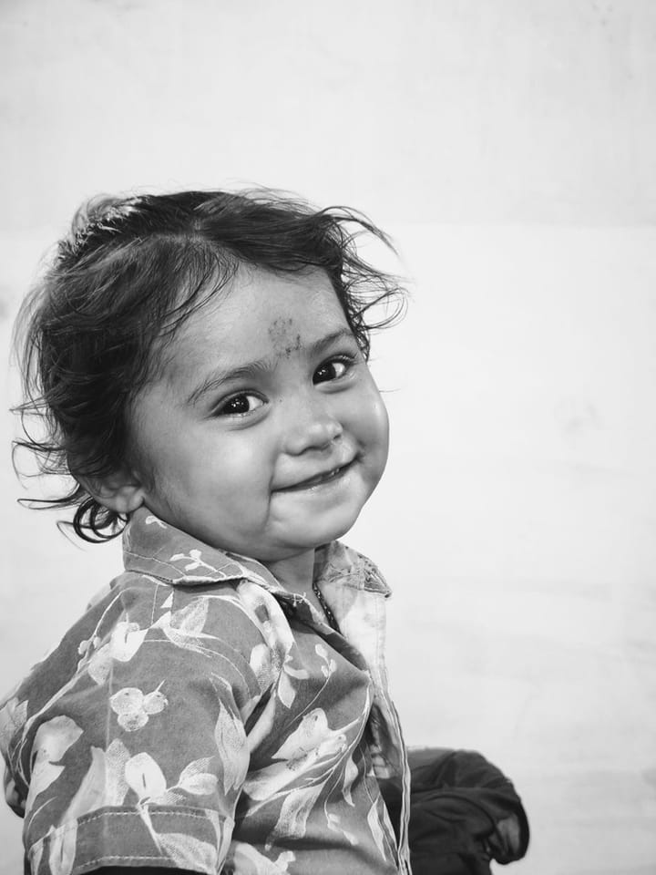Example photo: Black-and-white snapshot of a smiling toddler